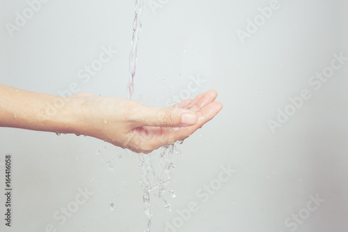 The Asian girl's hands are splashed with water.on white background