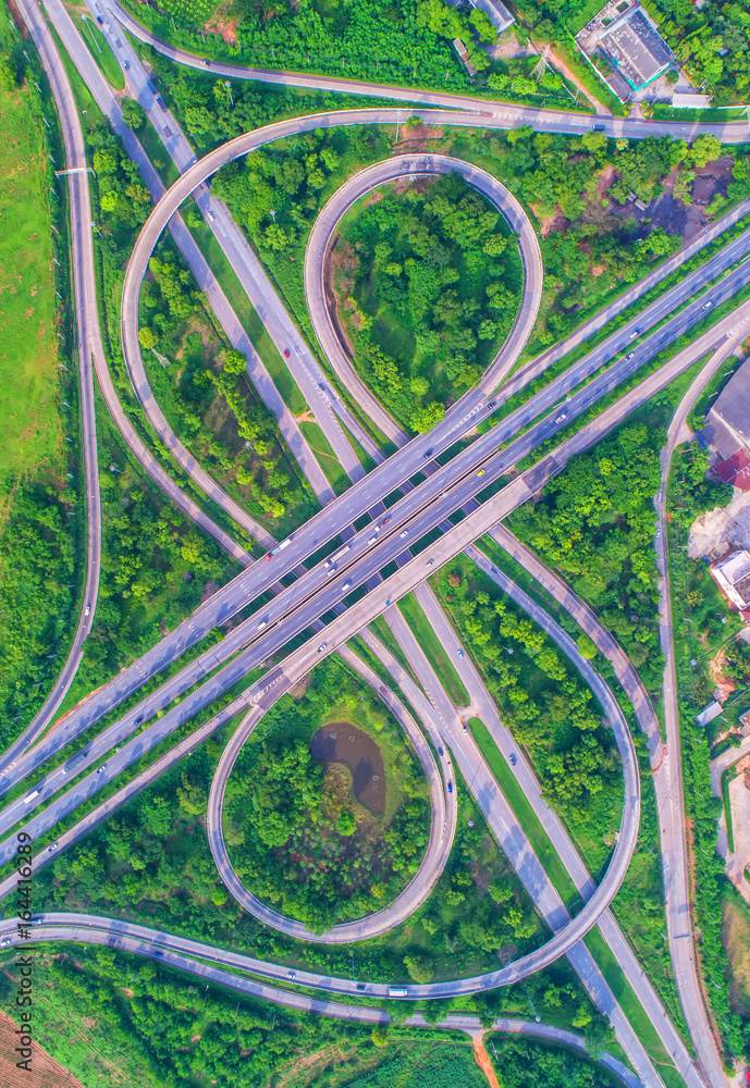 Aerial view, Road roundabout, Expressway with car lots in the city in Thailand. beautiful Street , downtown, cityscape, Top view. Background Aerial view, Road roundabout, Expressway with car lots in the city in Thailand. beautiful Street , downtown, cityscape, Top view. Background