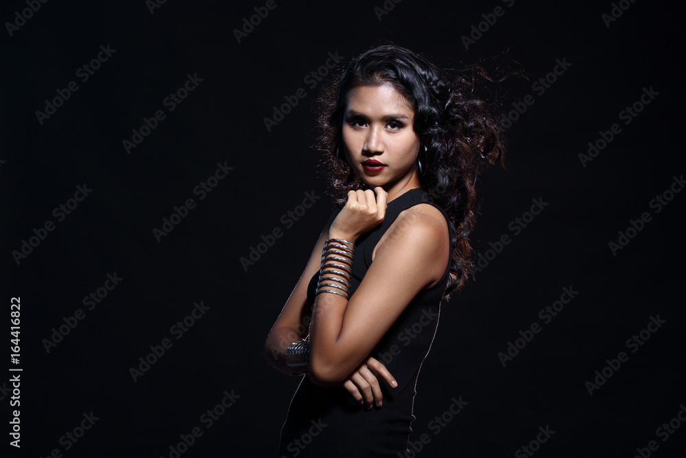 low key portrait of tan skin asian slim healthy woman in black background low key portrait of tan skin asian slim healthy woman in black background