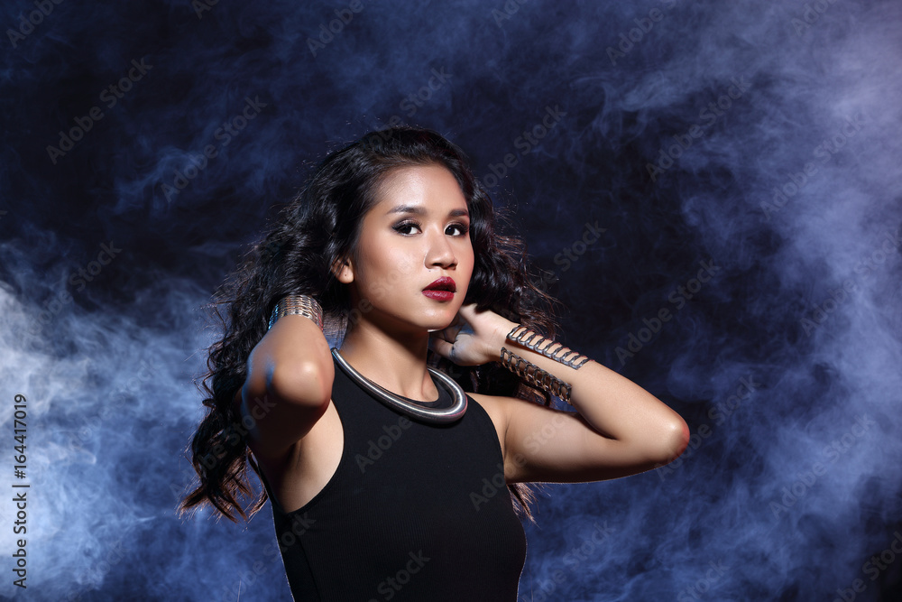low key portrait of tan skin asian slim healthy woman in black background low key portrait of tan skin asian slim healthy woman in black background