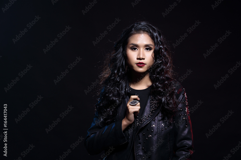 low key portrait of tan skin asian slim healthy woman in black background low key portrait of tan skin asian slim healthy woman in black background