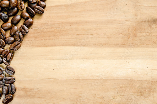 Roasted coffee beans on wooden floor