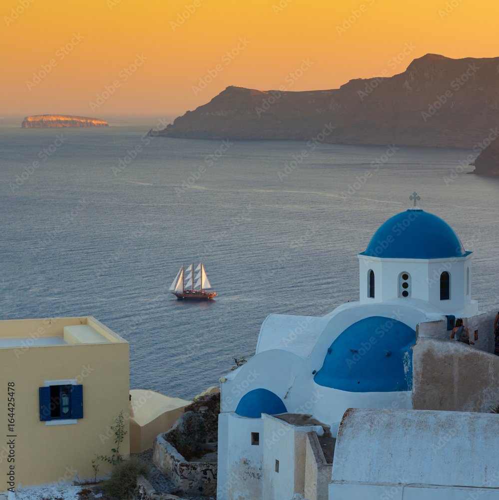 Santoronide blue-domed churches and sunset on the volcanic island, Greece
