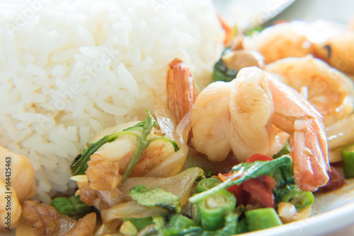 Stir-Fried Shrimps and Basil Rice Thai Food style has ready to served on white plate.