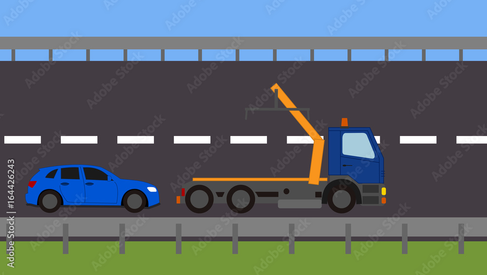 Tow truck picking up a vehicle on the road