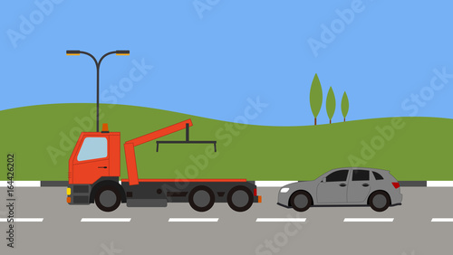Tow truck picking up a car in town
