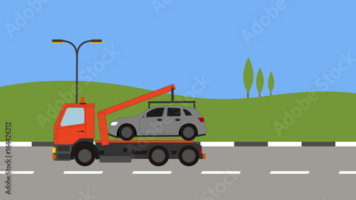 Tow truck picking up a car in town