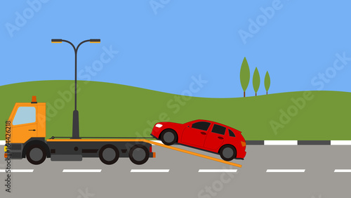 Tow truck picking up a car in town