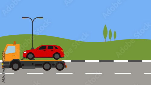 Tow truck picking up a car in town