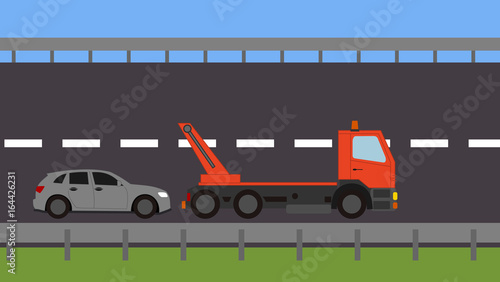 Tow truck picking up a vehicle on the road