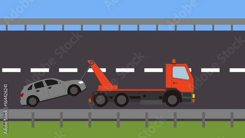 Tow truck picking up a vehicle on the road