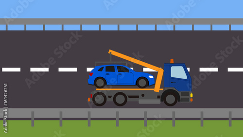 Tow truck picking up a vehicle on the road