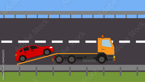 Tow truck picking up a vehicle on the road
