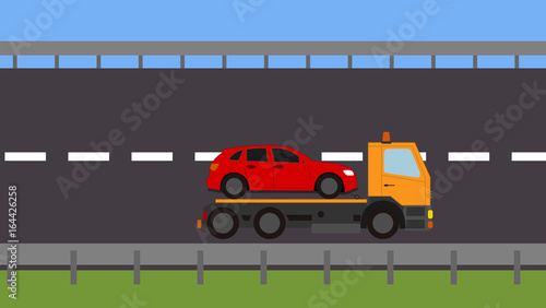 Tow truck picking up a vehicle on the road