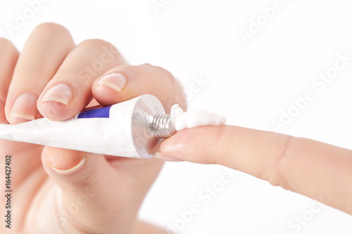 Behang Close up image of hands with cream tube