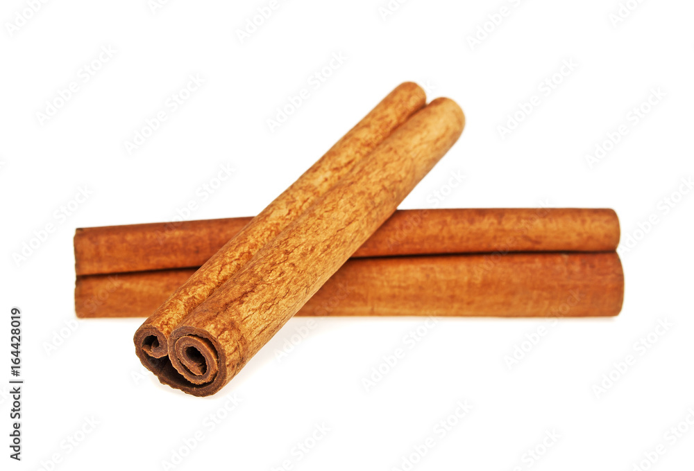 Two cinnamon sticks spice isolated on a white background, closeup Two cinnamon sticks spice isolated on a white background, closeup