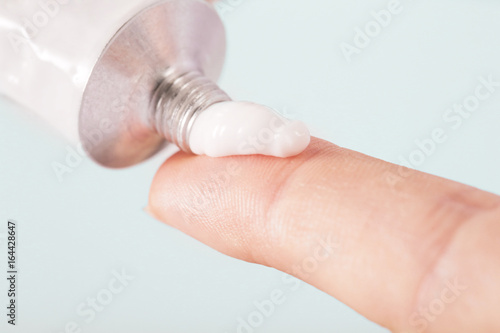 Fotografie Close up image of hands with cream tube