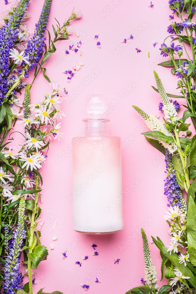 Natural cosmetic product bottle of lotion,shampoo or moisturizer with herbs and flowers on pink background, top view, copy space, vertical. Beauty, skin and hair care concept Natural cosmetic product bottle of lotion,shampoo or moisturizer with herbs and flowers on pink background, top view, copy space, vertical. Beauty, skin and hair care concept