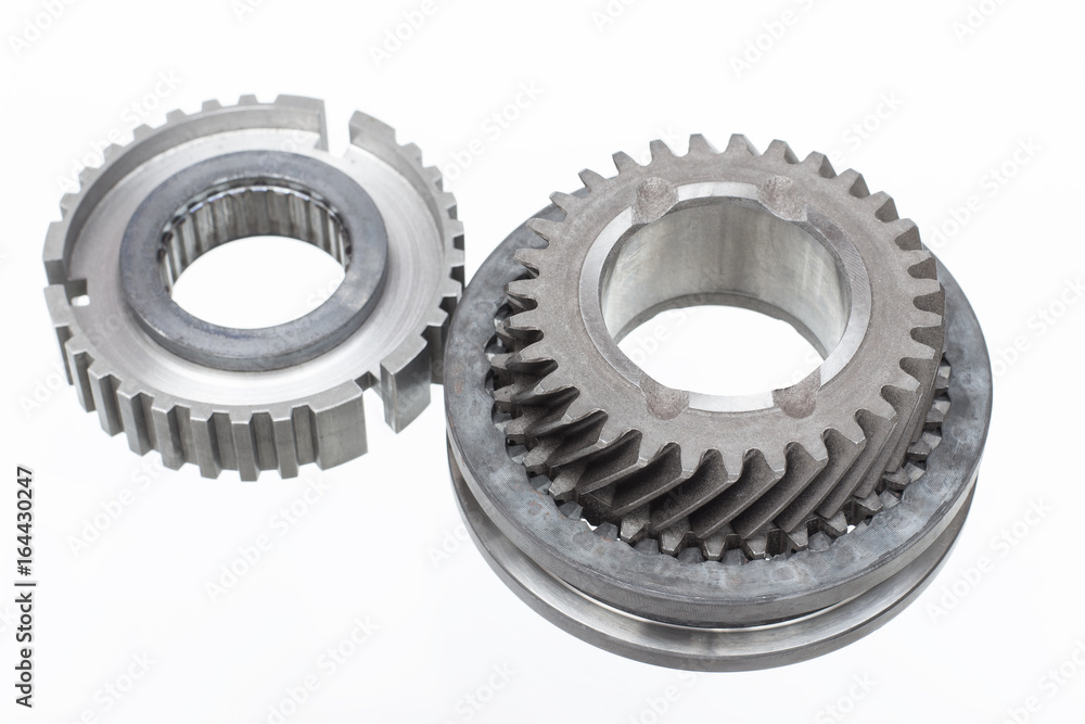 automobile transmission gear shafts on a light background