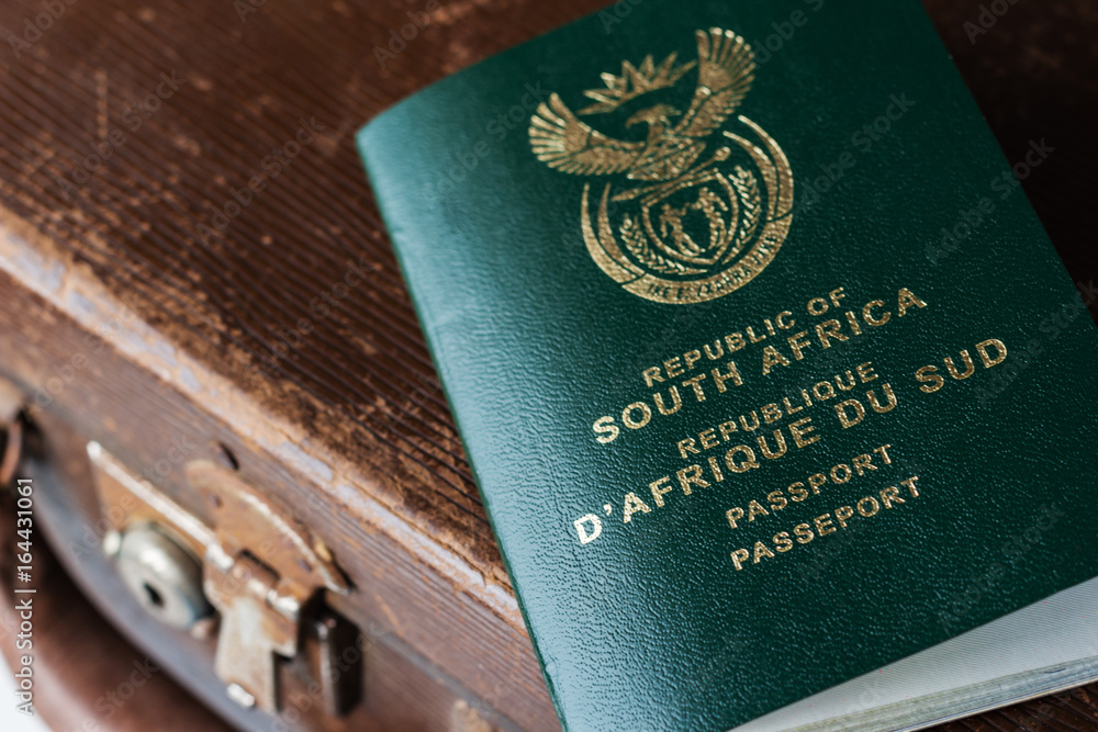 A South African passport on top of a vintage travel bag. This image can be  used to represent travel or immigration. Stock-Foto | Adobe Stock