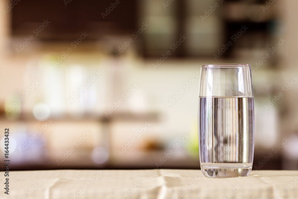 the Glass of purified water on the table bar in kitchen room