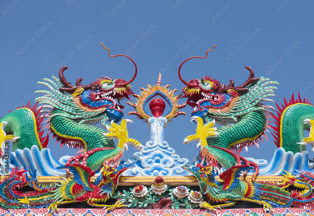 Chinese dragon statue on Chinese temple roof.
Chinese dragon statue on Chinese temple roof.