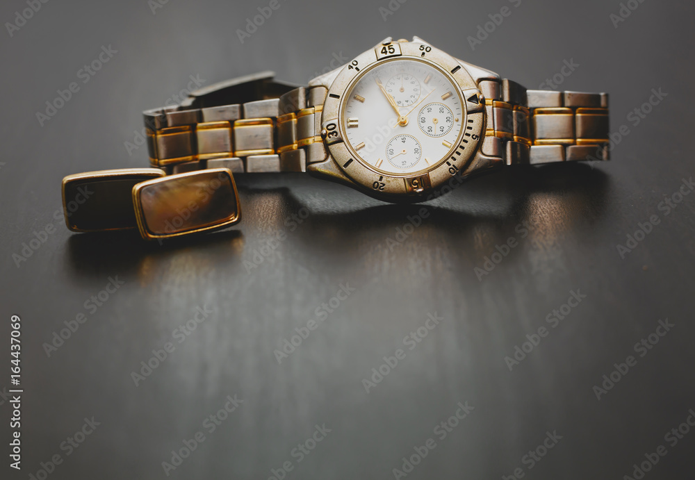 Stylish male watch with cuff in wooden background Stylish male watch with cuff in wooden background