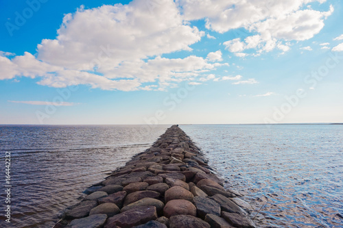 Stone pier going afar to the sea