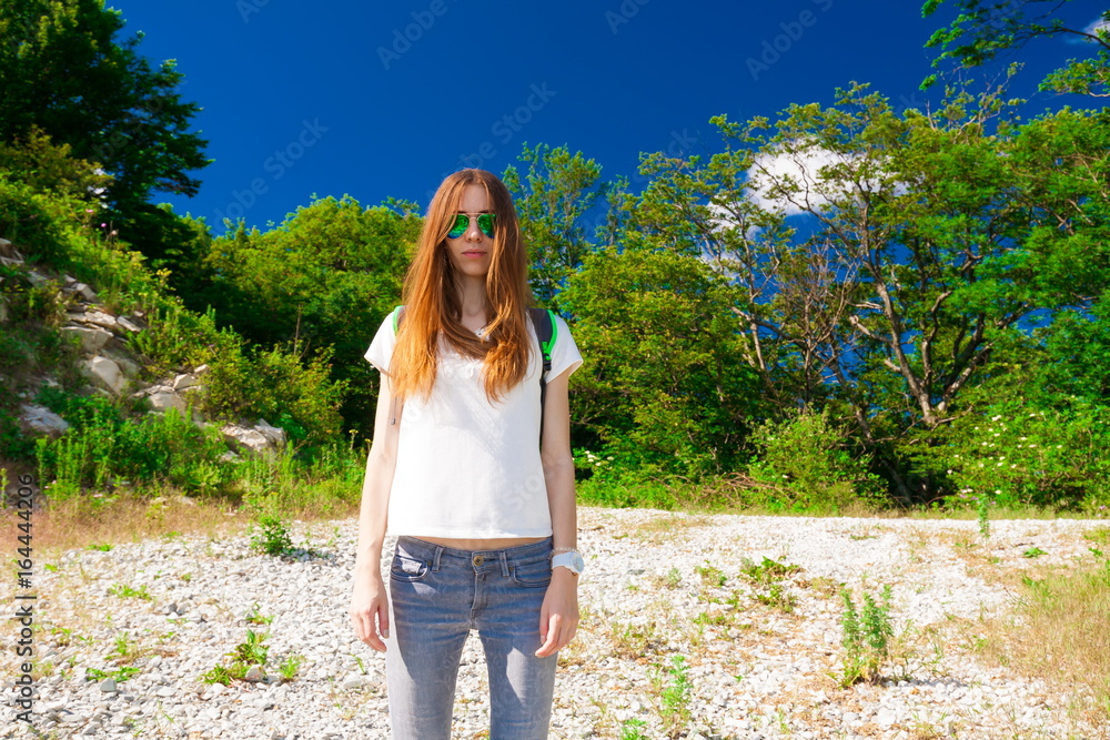 Mountain summer. Jeans, white t-shirt, sunglasses