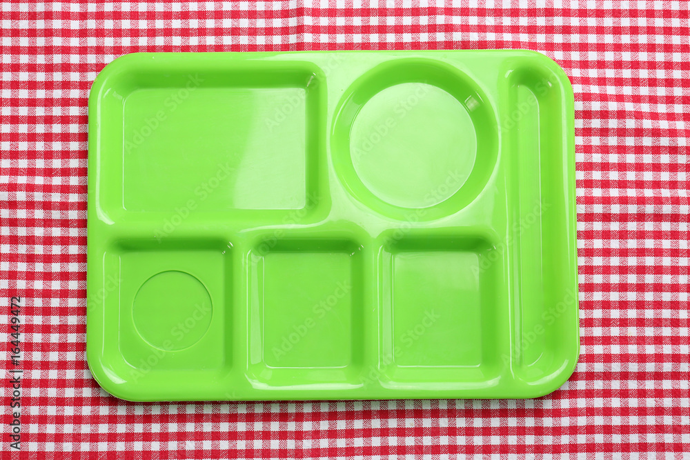 Empty serving tray for food on tablecloth. Concept of school lunch Empty serving tray for food on tablecloth. Concept of school lunch