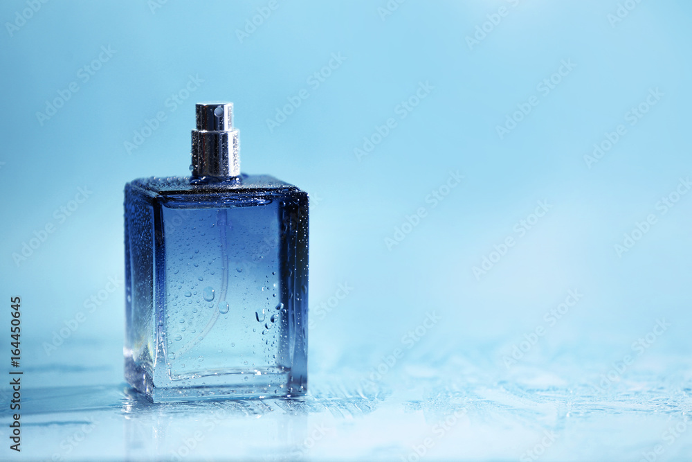 Bottle of modern male perfume on color background Bottle of modern male perfume on color background
