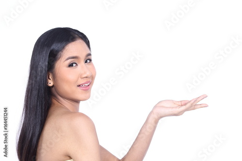 Beautiful Asia Thai woman with black hair face close up portrait studio on white, showing empty palm with copy space