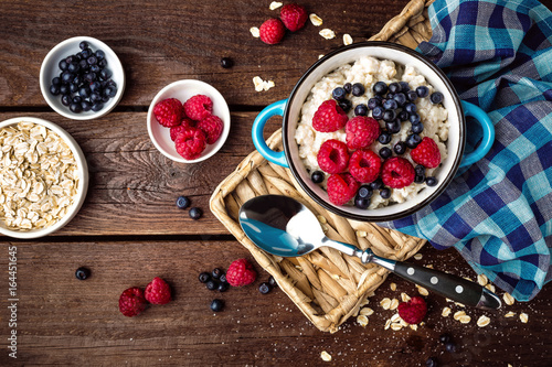 Oatmeal porridge with fresh berries, oats with blueberry and raspberry photo