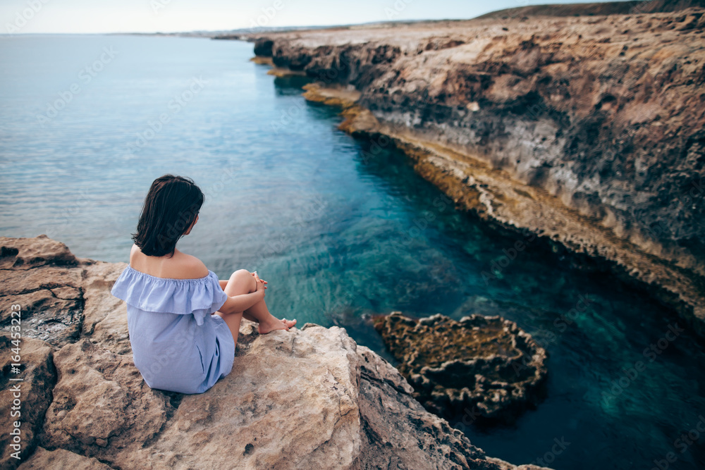 Young woman enjoying beautiful sea view on Greco cape in Cyprus Young woman enjoying beautiful sea view on Greco cape in Cyprus