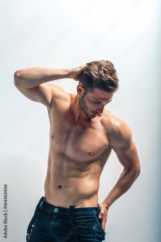 Fototapeta premium Sexy muscular shirtless man touching his hair