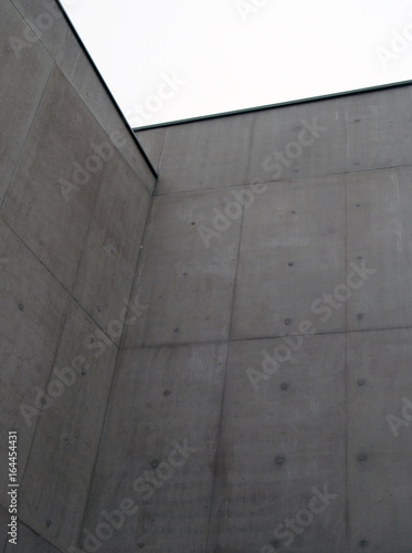 large concrete wall with corner cast panels and sky