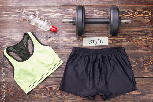 Female accessories for sport training. Top, shorts, dumbbell, bottle, message. Women sport activity. photo