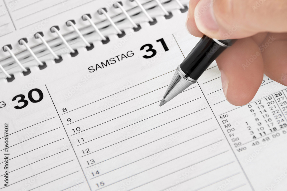 Hand, Kugelschreiber und Kalender Hand, Kugelschreiber und Kalender
