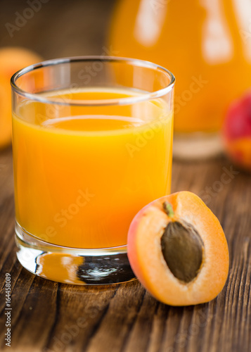 Wooden table with Apricot Juice (selective focus)