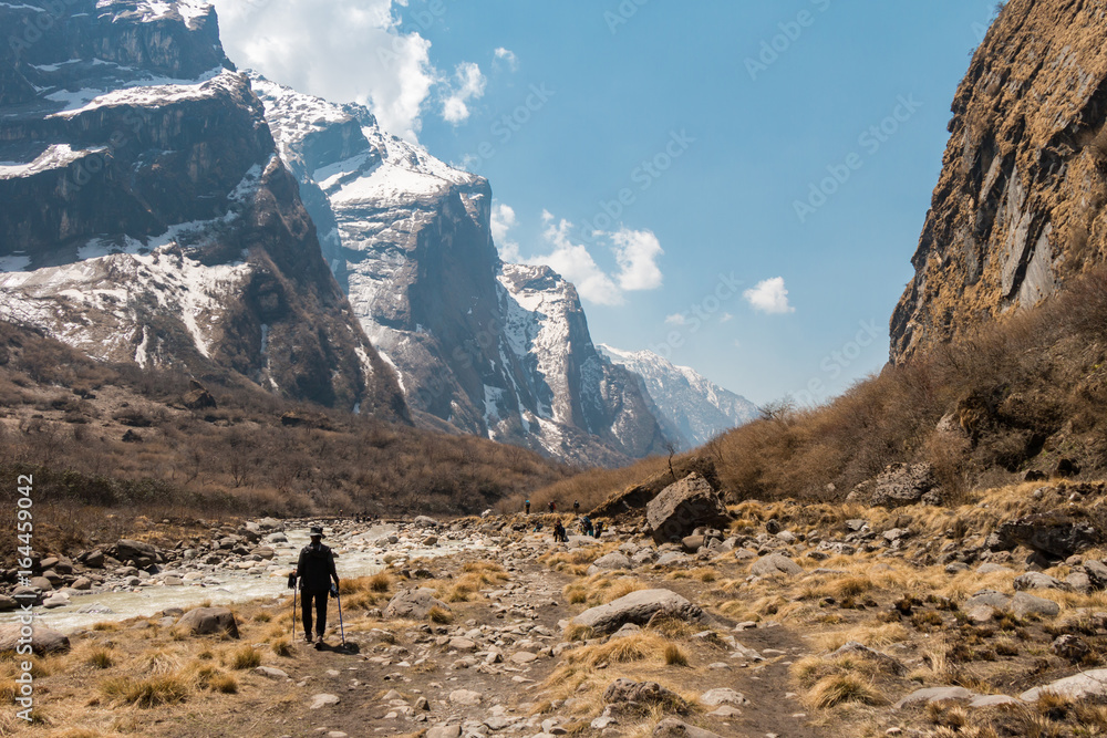 a trekking woman alone on the mountain route