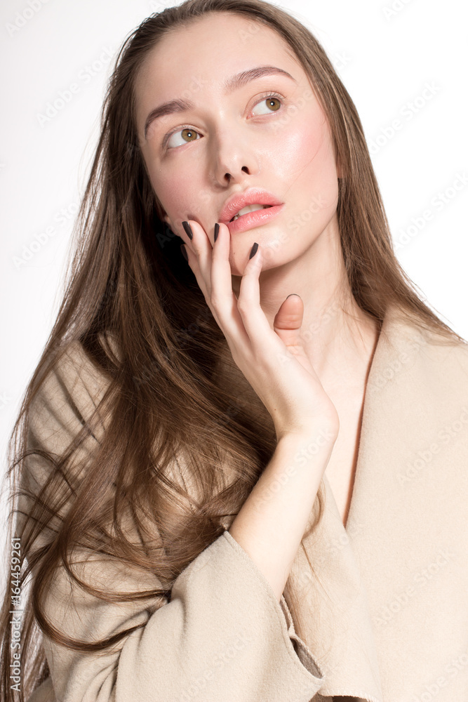 Awesome European attractive sexy fashion model with natural brunette hair, long eyelashes, full lips, perfect skin, posing in studio, wearing beige coat, beauty photoshot, retouched image Awesome European attractive sexy fashion model with natural brunette hair, long eyelashes, full lips, perfect skin, posing in studio, wearing beige coat, beauty photoshot, retouched image