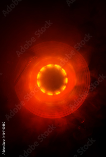 Concept of speed - Trail of fire and smoke - Vinyl record. Burning vinyl disk. Turntable vinyl record player. Retro audio equipment for disc jockey. Sound technology. Close up