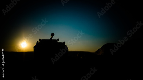 War Concept. Military silhouettes fighting scene on war fog sky background  World War Soldiers Silhouettes Below Cloudy Skyline At sunset. Attack scene. German tank in action