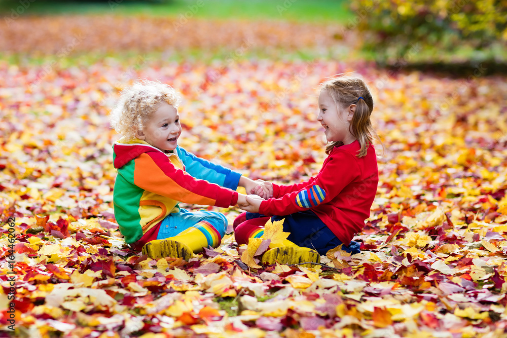 Kids play in autumn park. Children in fall. Kids play in autumn park. Children in fall.