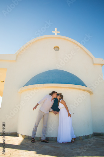 Romantic dating. Young loving couple holding hands and kissing photo