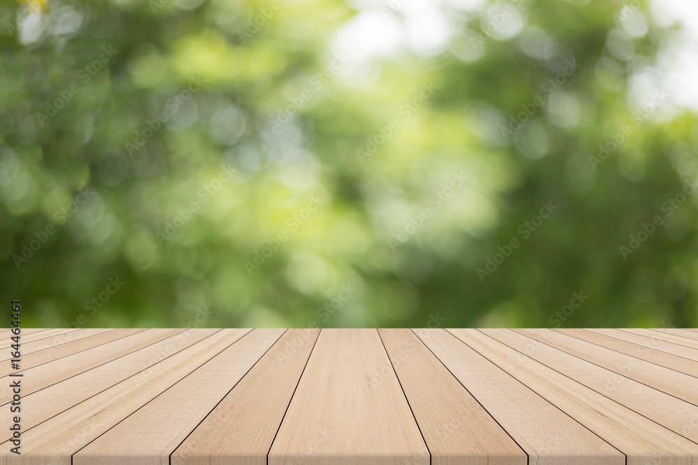 Wood table top on nature green blurred background,for montage your products Wood table top on nature green blurred background,for montage your products