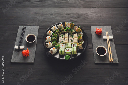 Eating set of sushi maki and rolls in japanese resaturant photo