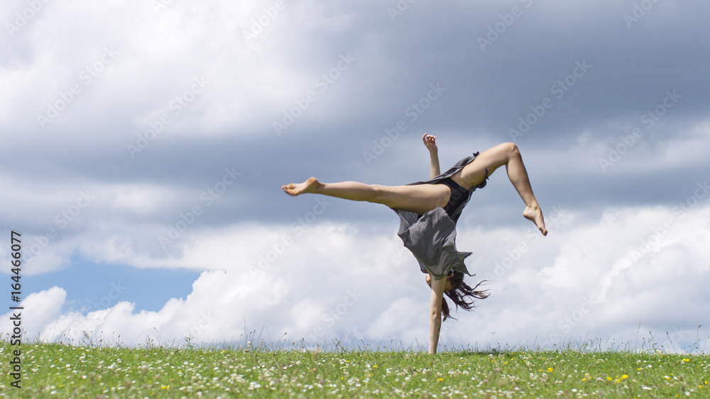 Young dancer doing a one handed forward cartwheel