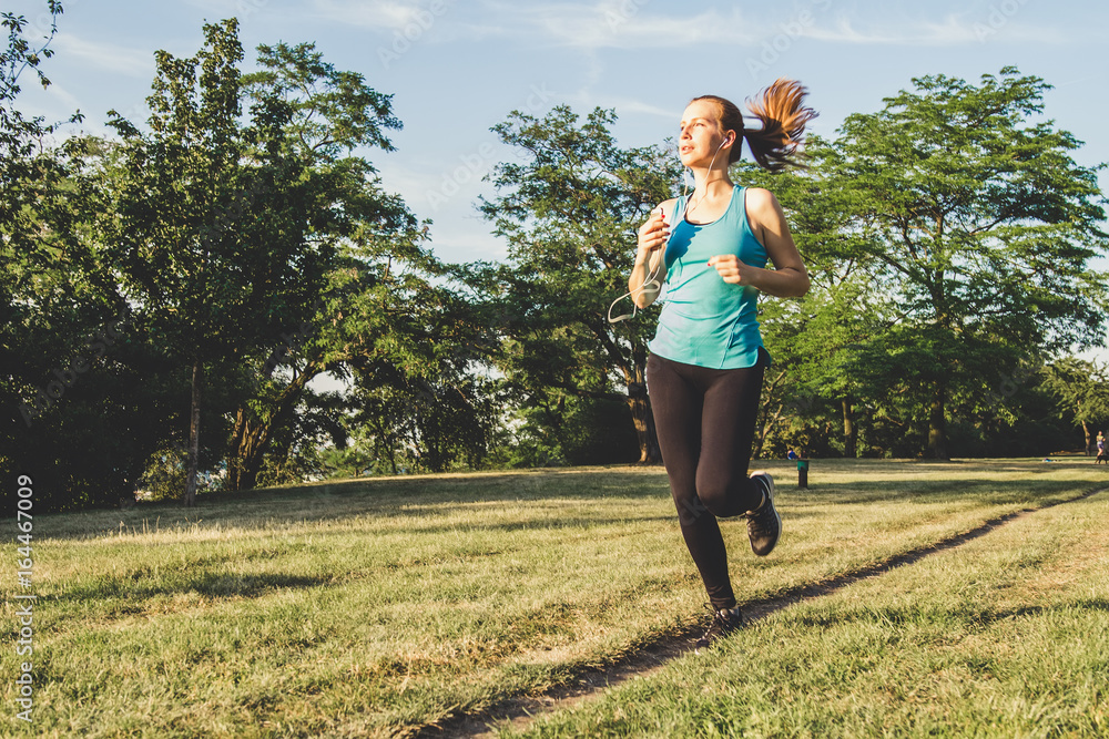 Young woman running, jogging in the park. Exercising outdoor Young woman running, jogging in the park. Exercising outdoor