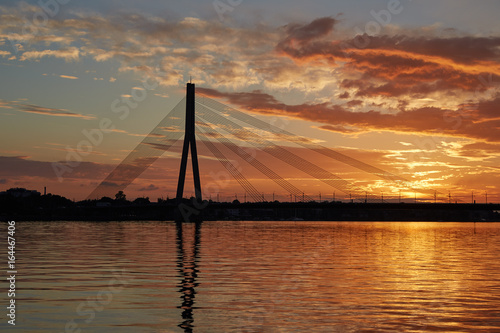 Silhouette of a cable-stayed bridge in Riga against a beautiful sunset
